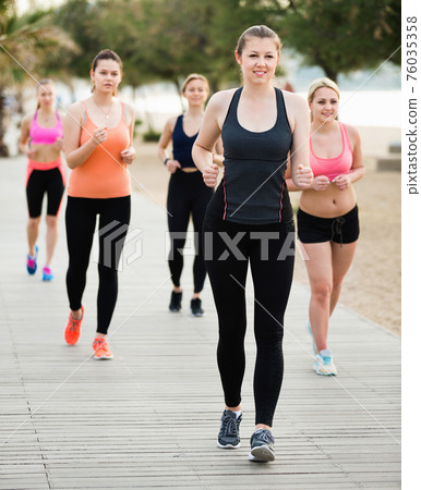 Women jogging during outdoor workout Women jogging during outdoor workout 76035358