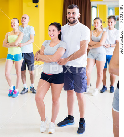 Enthusiastic men and women dancing salsa Enthusiastic men and women dancing salsa 76035495