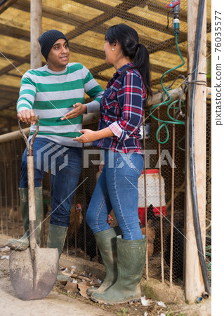 Man and woman farmers at poultry farm Man and woman farmers at poultry farm 76035577