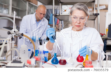 Female scientist working with reagents Female scientist working with reagents 76035579