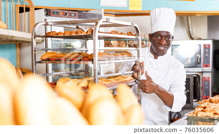 Cheerful baker in white uniform Cheerful baker in white uniform 76035606