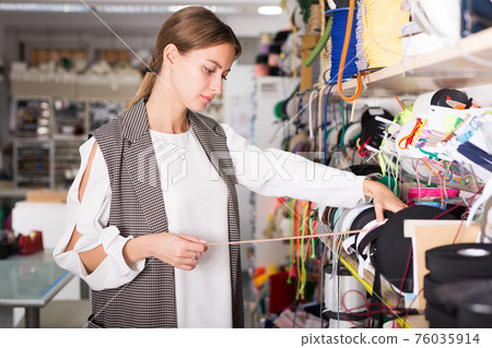 Girl choosing ribbons for needlecraft Girl choosing ribbons for needlecraft 76035914