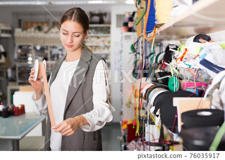 Woman choosing colorful ribbons Woman choosing colorful ribbons 76035917