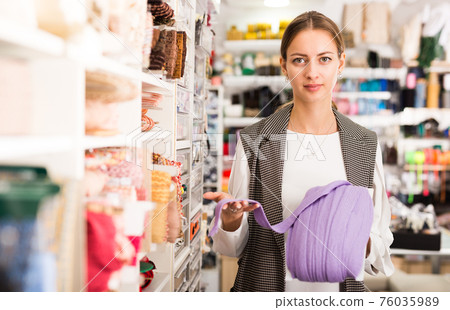 Saleswoman offering colorful ribbons Saleswoman offering colorful ribbons 76035989