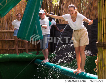 People passing horizontal bar at adventure park People passing horizontal bar at adventure park 76036221