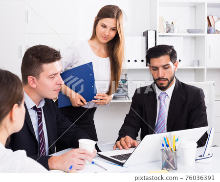 Business partners discussing in office 76036391