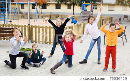 Active kids playing outdoors 76036429