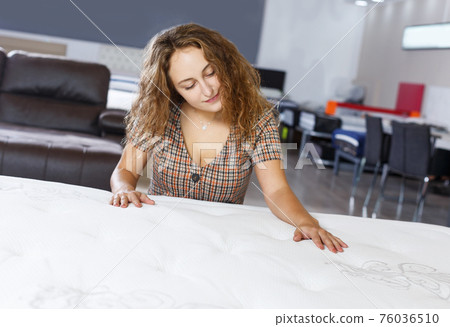 girl testing quality of new mattress 76036510