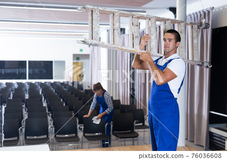 Workers redecorating conference hall Workers redecorating conference hall 76036608
