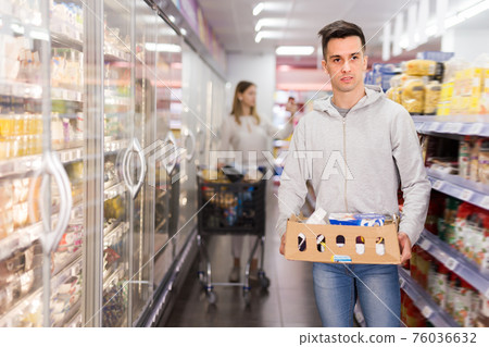 Positive male customer with cardboard box Positive male customer with cardboard box 76036632