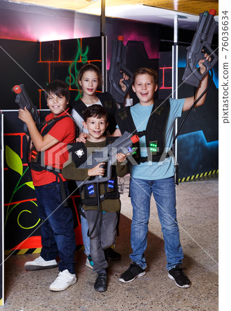 teen kids with laser guns during lasertag game 76036634
