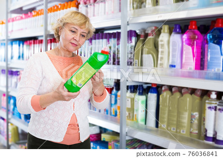 Female holding goods for cleaning house in shop Female holding goods for cleaning house in shop 76036841