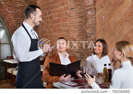 Male waiter taking order from visitors 76036860