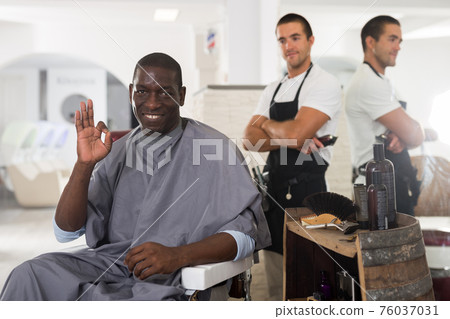 African man approving result of hairdresser work African man approving result of hairdresser work 76037031