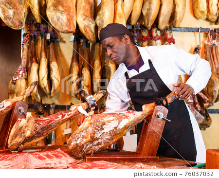 Butcher checking quality of jamon Butcher checking quality of jamon 76037032