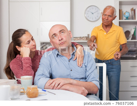 Wife comforting husband after a family conflict Wife comforting husband after a family conflict 76037106