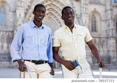 Portrait of happy friends tourists on tour of the European city Portrait of happy friends tourists on tour of the European city 76037153