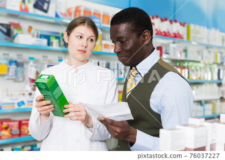 woman pharmacist discussing prescription medicines with man woman pharmacist discussing prescription medicines with man 76037227