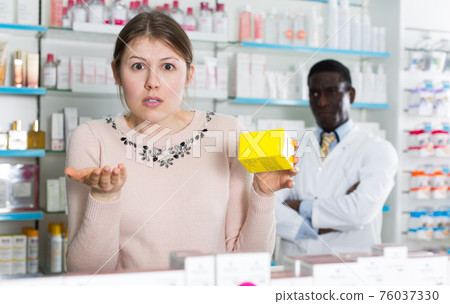 surprised by prices woman holding medicine surprised by prices woman holding medicine 76037330