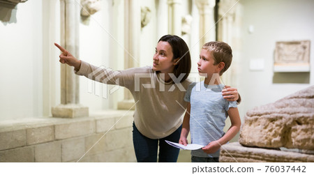 Woman and boy observing sculptures exhibition Woman and boy observing sculptures exhibition 76037442