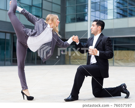 Couple of managers are dancing 76037597