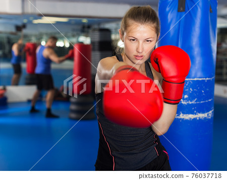 Woman boxing in gym Woman boxing in gym 76037718