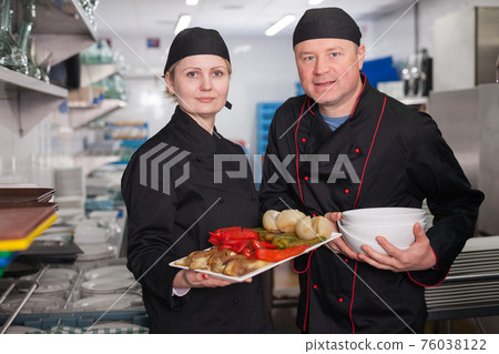 Two cooks with cooked dish Two cooks with cooked dish 76038122