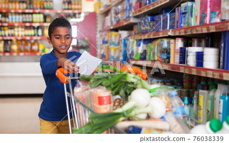 African boy shopping in grocery African boy shopping in grocery 76038339