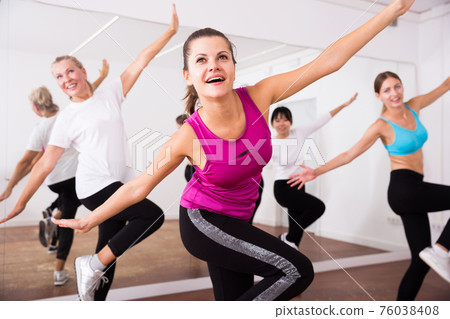 Cheerful different ages women learning swing steps at dance class Cheerful different ages women learning swing steps at dance class 76038408