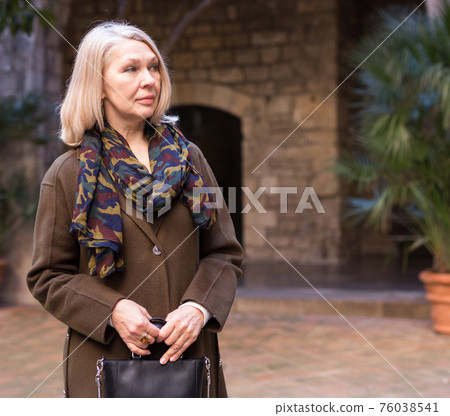 Portrait of an elegant elderly woman on spring street of european city Portrait of an elegant elderly woman on spring street of european city 76038541
