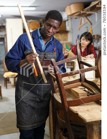 Professional restorer renewing vintage armchair 76038594