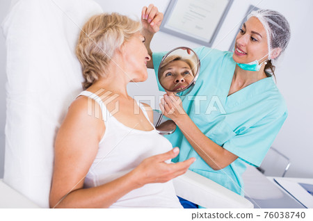 Doctor beautician discussing with woman 76038740