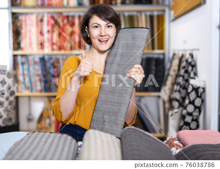 Woman showing thumbs up in tissue store Woman showing thumbs up in tissue store 76038786