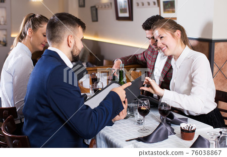 Friends choosing meal from menu Friends choosing meal from menu 76038867