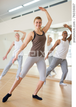Happy adults training swing steps at class 76038887