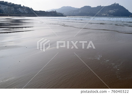Sandy beach on the beach of La Concha, Spain 76040322