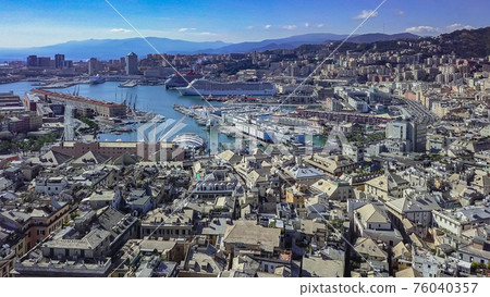 Aerial panoramic drone view of buildings and streets surrounding Port of Genoa.Cruise ship in port. 76040357