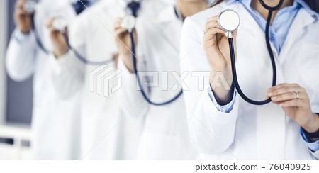 Group of doctors holding stethoscope head close-up. Physicians ready to examine and help patient. Medicine concept 76040925