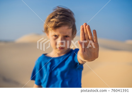 Boy calls for an end to climate change. No trash, no greenhouse gases, reduced carbon dioxide emissions Boy calls for an end to climate change. No trash, no greenhouse gases, reduced carbon dioxide emissions 76041391