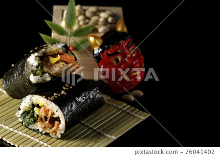 Korean style thick roll, demon mask and soybeans photographed on a black background 76041402