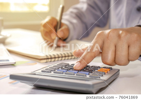 Close-up of women using calculators and note-taking, accounting reports, cost-calculation ideas and saving money. 76041869