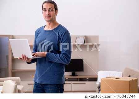 Young man moving to new flat Young man moving to new flat 76043744