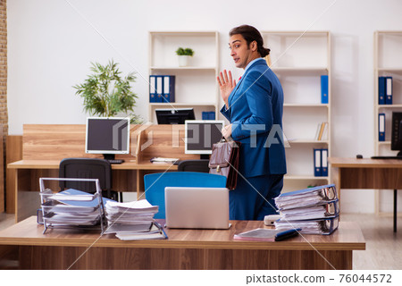 Young male employee working in the office Young male employee working in the office 76044572