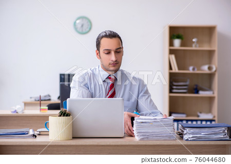 Young male employee in time management concept 76044680