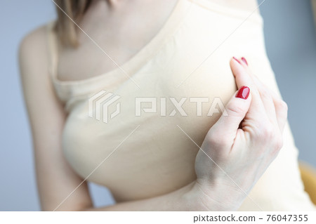 Woman feels pain in chest area concept Woman feels pain in chest area concept 76047355