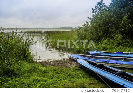 three kayaks on the lake 76047715