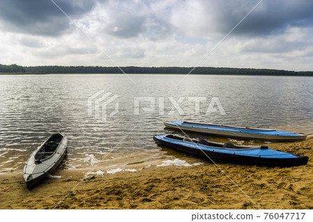 three kayaks on the lake 76047717