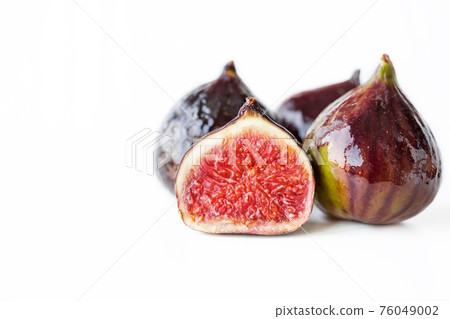A few ripe figs on an old wooden background. 76049002