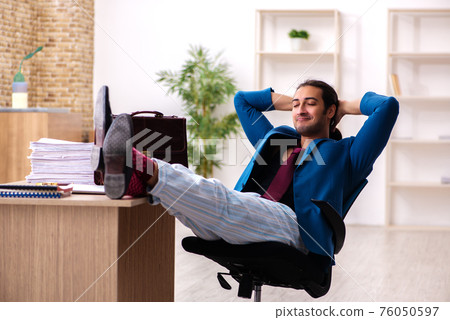 Young male employee in oversleeping concept 76050597