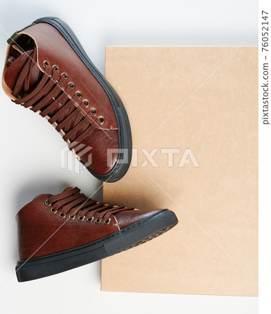 Pair of brown leather shoes on paper box Pair of brown leather shoes on paper box 76052147
